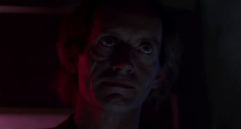 Movie still from “Near Dark” (1987), directed by Kathryn Bigelow – A person looking up at the camera; Close Up shot, Low angle