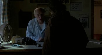 Movie still from “Near Dark” (1987), directed by Kathryn Bigelow – An older man is talking to a younger man; Medium shot, Over the shoulder angle