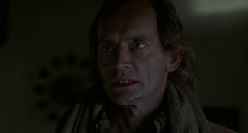 Movie still from “Near Dark” (1987), directed by Kathryn Bigelow – A person with a scar on his face; Close Up shot, Low angle