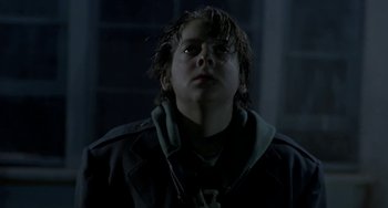 Movie still from “Near Dark” (1987), directed by Kathryn Bigelow – A young boy looking up into the dark; Close Up shot, Low angle