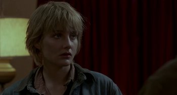 Movie still from “Near Dark” (1987), directed by Kathryn Bigelow – A woman in a blue jacket is looking to her left; Close Up shot, Over the shoulder angle