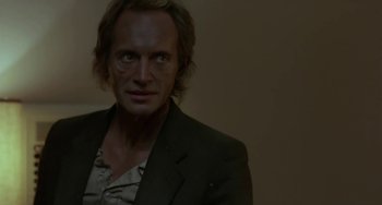 Movie still from “Near Dark” (1987), directed by Kathryn Bigelow – A person wearing a suit; Close Up shot, Over the shoulder angle