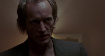 Movie still from “Near Dark” (1987), directed by Kathryn Bigelow – A person wearing a suit; Close Up shot, Low angle