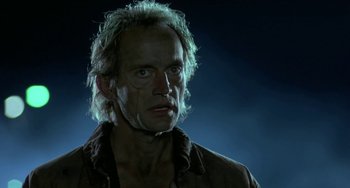 Movie still from “Near Dark” (1987), directed by Kathryn Bigelow – A person wearing a shirt and looking at the camera; Close Up shot, Low angle