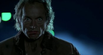 Movie still from “Near Dark” (1987), directed by Kathryn Bigelow – A man's face in the dark; Close Up shot, Low angle