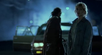 Movie still from “Near Dark” (1987), directed by Kathryn Bigelow – Two people standing on the side of the street; Medium shot, Over the shoulder angle