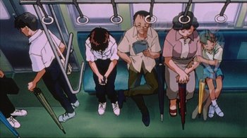 Movie still from “Neon Genesis Evangelion: Death & Rebirth” (1997), directed by Tensai Okamura – A group of people sitting on a subway train; Wide shot, High angle