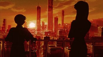 Movie still from “Neon Genesis Evangelion: Death & Rebirth” (1997), directed by Tensai Okamura – Two people looking out over a city at sunset; Wide shot, Low angle