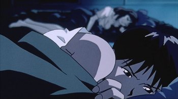 Movie still from “Neon Genesis Evangelion: Death & Rebirth” (1997), directed by Tensai Okamura – A man laying on the ground in a dark room; Close Up shot, Low angle