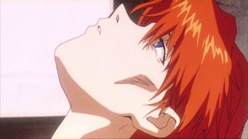 Movie still from “Neon Genesis Evangelion: Death & Rebirth” (1997), directed by Tensai Okamura – A woman's face with red hair and blue eyes; Extreme Close Up shot, Low angle