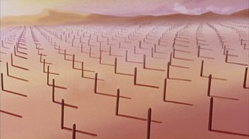 Movie still from “Neon Genesis Evangelion: Death & Rebirth” (1997), directed by Tensai Okamura – An image of a field of sticks in the sand; Extreme Wide shot, High angle