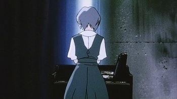 Movie still from “Neon Genesis Evangelion: Death & Rebirth” (1997), directed by Tensai Okamura – A woman standing in front of an open piano; Medium shot, Low angle
