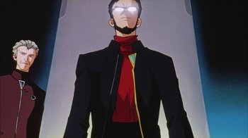 Movie still from “Neon Genesis Evangelion: Death & Rebirth” (1997), directed by Tensai Okamura – A man in a black jacket and a red tie; Medium shot, Low angle