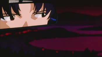 Movie still from “Neon Genesis Evangelion: Death & Rebirth” (1997), directed by Tensai Okamura – The reflection of a person in the rear view mirror of a car; Close Up shot, Low angle