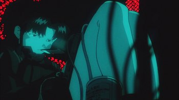 Movie still from “Neon Genesis Evangelion: Death & Rebirth” (1997), directed by Tensai Okamura – A person in a car seat at night; Close Up shot, Low angle