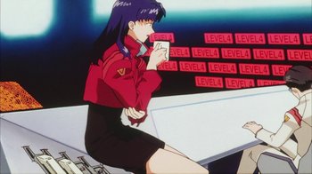 Movie still from “Neon Genesis Evangelion: Death & Rebirth” (1997), directed by Tensai Okamura – A woman sitting on top of a table in front of a wall; Medium shot, Low angle