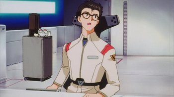Movie still from “Neon Genesis Evangelion: Death & Rebirth” (1997), directed by Tensai Okamura – A man with glasses is sitting at a desk; Medium shot, Low angle