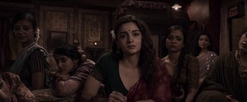 Movie still from “Gangubai Kathiawadi” (2022), directed by Sanjay Leela Bhansali – A woman in a green shirt and a red sari; Medium shot, Over the shoulder angle