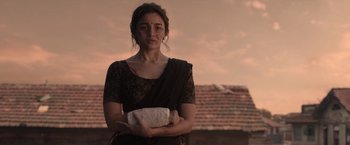Movie still from “Gangubai Kathiawadi” (2022), directed by Sanjay Leela Bhansali – A woman in a sari holding a piece of paper; Medium shot, Low angle