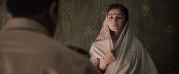 Movie still from “Gangubai Kathiawadi” (2022), directed by Sanjay Leela Bhansali – A woman in a sari looking into a mirror; Close Up shot, Low angle