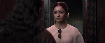 Movie still from “Gangubai Kathiawadi” (2022), directed by Sanjay Leela Bhansali – A woman in a white dress looking into a mirror; Close Up shot, Over the shoulder angle