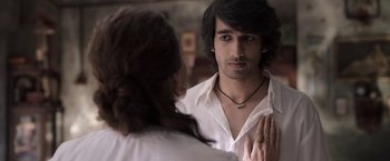 Movie still from “Gangubai Kathiawadi” (2022), directed by Sanjay Leela Bhansali – A man and a woman looking in the same direction in the same mirror; Close Up shot, Over the shoulder angle