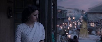 Movie still from “Gangubai Kathiawadi” (2022), directed by Sanjay Leela Bhansali – A woman standing in front of a window at night; Medium shot, Low angle