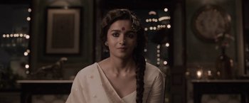 Movie still from “Gangubai Kathiawadi” (2022), directed by Sanjay Leela Bhansali – A woman in a white dress with a long braid; Close Up shot, Low angle