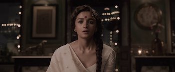 Movie still from “Gangubai Kathiawadi” (2022), directed by Sanjay Leela Bhansali – A woman in a white dress with a red dot on her forehead; Close Up shot, Low angle