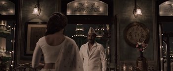 Movie still from “Gangubai Kathiawadi” (2022), directed by Sanjay Leela Bhansali – A man and a woman are standing in front of a building; Medium shot, Over the shoulder angle