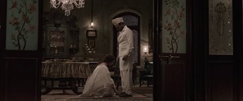 Movie still from “Gangubai Kathiawadi” (2022), directed by Sanjay Leela Bhansali – A man and a woman dressed in formal clothes; Wide shot, High angle