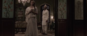 Movie still from “Gangubai Kathiawadi” (2022), directed by Sanjay Leela Bhansali – A man and a woman standing in front of a doorway; Wide shot, Low angle