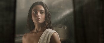 Movie still from “Gangubai Kathiawadi” (2022), directed by Sanjay Leela Bhansali – A woman in a white dress is standing in front of a mirror; Close Up shot, Low angle