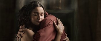 Movie still from “Gangubai Kathiawadi” (2022), directed by Sanjay Leela Bhansali – A young woman hugging a pillow in a dark room; Close Up shot, Low angle