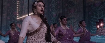 Movie still from “Gangubai Kathiawadi” (2022), directed by Sanjay Leela Bhansali – Two women in traditional indian garb sing a song; Medium shot, Low angle