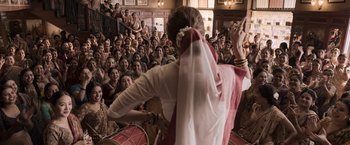 Movie still from “Gangubai Kathiawadi” (2022), directed by Sanjay Leela Bhansali – A crowd of people watching a woman sing; Wide shot, High angle
