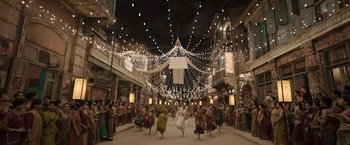 Movie still from “Gangubai Kathiawadi” (2022), directed by Sanjay Leela Bhansali – A group of people are dancing in the middle of an indoor area; Extreme Wide shot, High angle