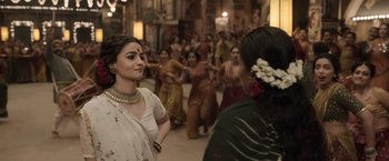 Movie still from “Gangubai Kathiawadi” (2022), directed by Sanjay Leela Bhansali – A group of women in traditional indian garb dancing; Medium shot, Over the shoulder angle