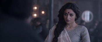 Movie still from “Gangubai Kathiawadi” (2022), directed by Sanjay Leela Bhansali – A woman with long black hair and a red dot on her forehead; Close Up shot, Over the shoulder angle