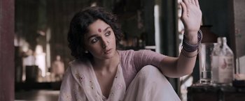 Movie still from “Gangubai Kathiawadi” (2022), directed by Sanjay Leela Bhansali – A woman sitting on the ground in a room; Close Up shot, Low angle
