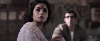 Movie still from “Gangubai Kathiawadi” (2022), directed by Sanjay Leela Bhansali – A woman with a red dot on her forehead and a man in a suit; Close Up shot, Over the shoulder angle