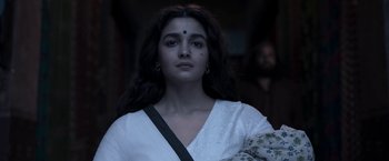 Movie still from “Gangubai Kathiawadi” (2022), directed by Sanjay Leela Bhansali – A woman with long dark hair wearing a white dress; Close Up shot, Low angle