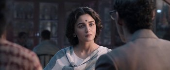 Movie still from “Gangubai Kathiawadi” (2022), directed by Sanjay Leela Bhansali – A woman in a white shirt and a black and white scarf; Close Up shot, Over the shoulder angle