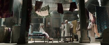 Movie still from “Gangubai Kathiawadi” (2022), directed by Sanjay Leela Bhansali – A group of people standing around a room; Wide shot, Low angle