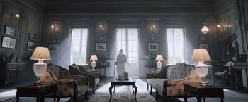 Movie still from “Gangubai Kathiawadi” (2022), directed by Sanjay Leela Bhansali – A woman standing in a living room in front of a window; Extreme Wide shot, Low angle