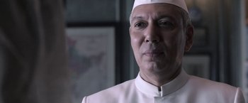 Movie still from “Gangubai Kathiawadi” (2022), directed by Sanjay Leela Bhansali – A person wearing a white hat; Close Up shot, Low angle