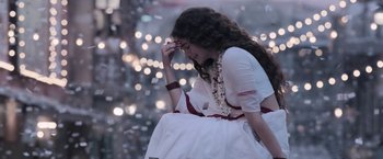 Movie still from “Gangubai Kathiawadi” (2022), directed by Sanjay Leela Bhansali – A woman in a white dress is sitting on the ground; Medium shot, Low angle