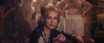 Movie still from “Neruda” (2016), directed by Pablo Larraín – A woman sitting in front of a group of people; Close Up shot, Over the shoulder angle