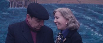 Movie still from “Neruda” (2016), directed by Pablo Larraín – A man and a woman standing next to each other near a body of water; Close Up shot, Over the shoulder angle