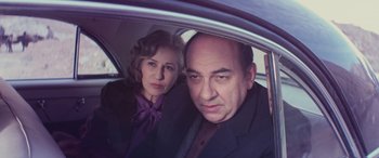 Movie still from “Neruda” (2016), directed by Pablo Larraín – A man and a woman sitting in the back of a car; Close Up shot, High angle